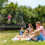 Family Enjoying Springfree Compact Oval Trampoline O47 In Backyard